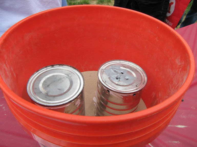 Two Cans in a Bucket of Sand